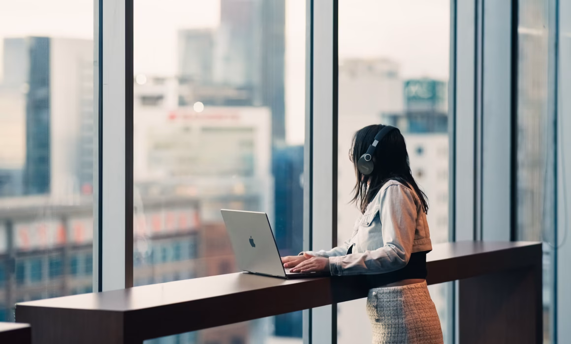 Person trying to concentrate at a desk by a window, representing daytime tinnitus distress addressed by tinnitus hypnotherapy in London